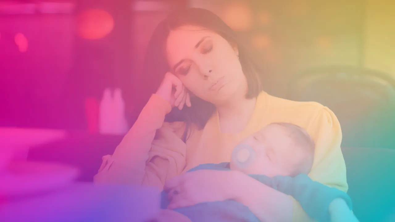 A quiet portrait of a mother holding her baby, expression thoughtful